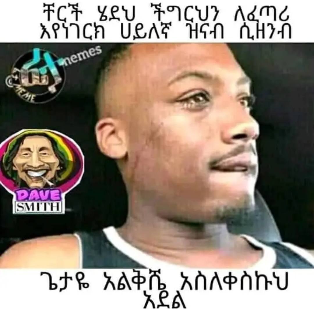 a man with a black face and a white shirt